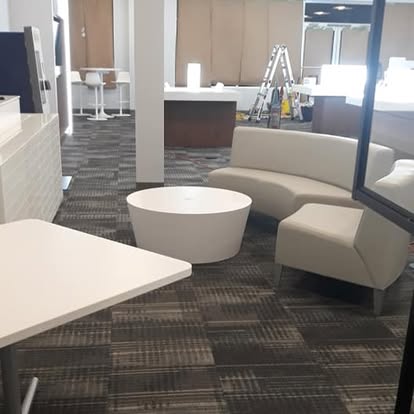 Office lobby waiting area with couches and carpet