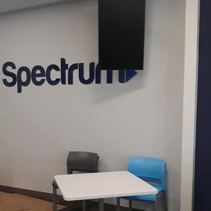 Spectrum retail store interior with logo signage and seating