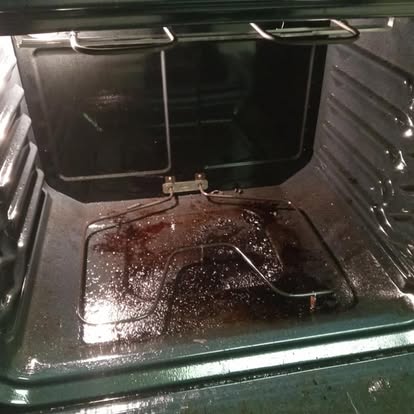 Oven interior before deep cleaning with burnt residue on floor