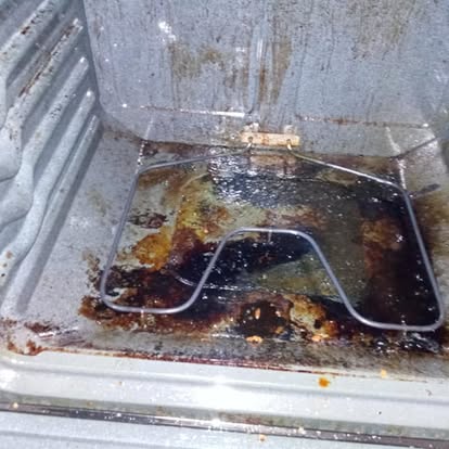 Oven interior before deep cleaning with heavy burnt-on residue